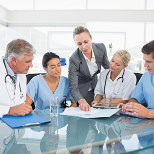 44777286 - team of doctors and businesswoman having a meeting in medical office